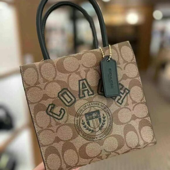 Coach Handbags - NWT Coach Mini Cally Crossbody In Signature Canvas With Varsity Motif cf381